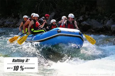 a group of people in a raft on a river at Apartments Bovec House Center in Bovec