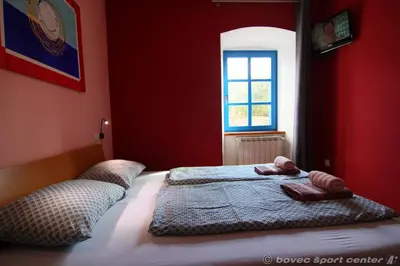 a bedroom with a bed with two towels on it at Apartments Bovec House Center in Bovec