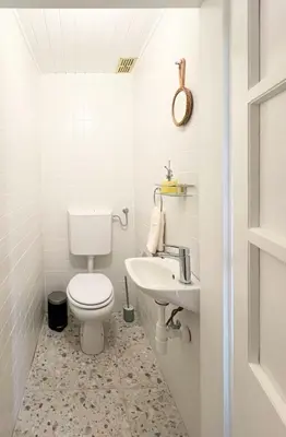 a white bathroom with a toilet and a sink at Maria's Orchard Cottage - Nature Retreat in Slovenia in Rogaška Slatina
