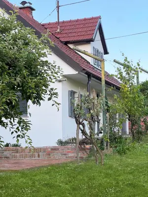 a white house with a red roof at Maria's Orchard Cottage - Nature Retreat in Slovenia in Rogaška Slatina