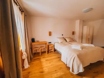 a bedroom with a bed and a table in it at Maison Lenka in Rateče