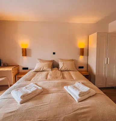 a bedroom with a large bed with two pillows on it at Maison Lenka in Rateče