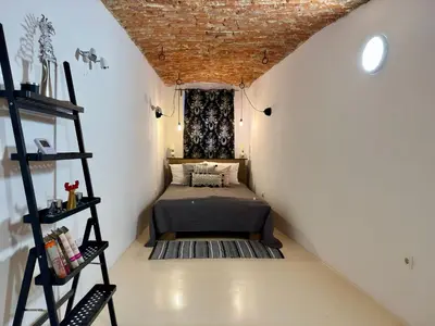 a small bedroom with a bed in a attic at Vila Kralj in Podčetrtek