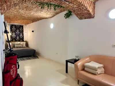 a living room with a couch and a bed at Vila Kralj in Podčetrtek