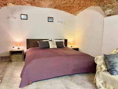a bedroom with a bed and a couch at Vila Kralj in Podčetrtek