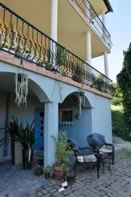 a house with two chairs and a balcony at Vila Kralj in Podčetrtek