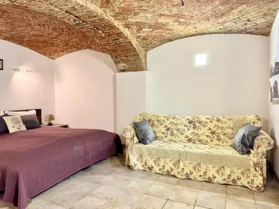 a living room with a couch and a bed at Vila Kralj in Podčetrtek