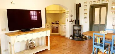 a kitchen with a flat screen tv on a table at Karsolina in Štanjel