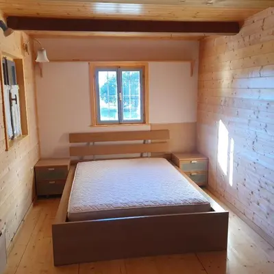 a bedroom with a bed and a window at Karsolina in Štanjel