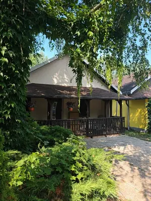 a house with a porch and a fence at Hiška 4005 - Terme Čatež in Brežice