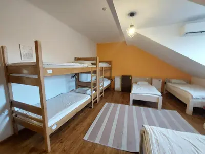 a room with four bunk beds in a attic at Bella Veselova in Ljubljana