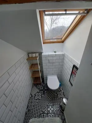 a small bathroom with a toilet and a window at Bella Veselova in Ljubljana
