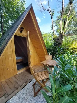 a wooden cabin with a bench and a porch at Bella Veselova in Ljubljana
