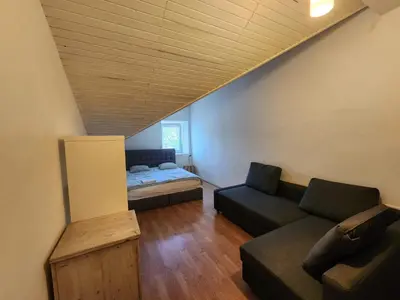 a living room with a bed and a couch at Bella Veselova in Ljubljana
