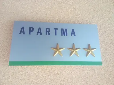 a blue sign with three stars on a wall at Apartment Tijana in Nomenj