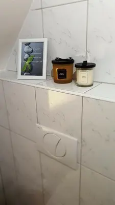 a shelf with three pots and a picture on it at Apartment Tijana in Nomenj