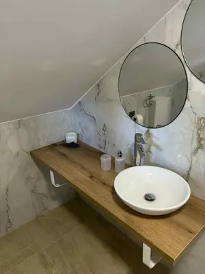 a bathroom with a sink and a mirror at Apartma Lavanda in Zavrč