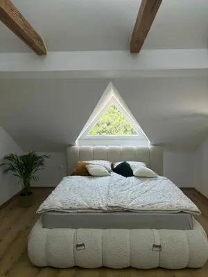 a bedroom with a large bed with a window at Apartma Lavanda in Zavrč
