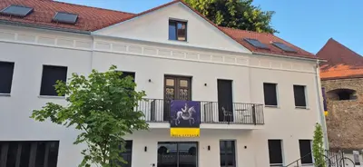 a white building with a red roof at Hiša Barbara in Celje