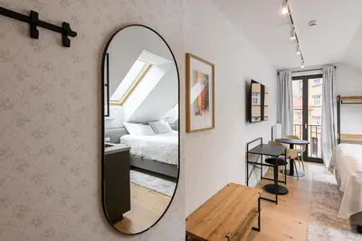 a bedroom with a mirror and a bed and a table at Hiša Barbara in Celje