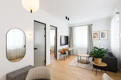 a living room with a couch and a mirror at Hiša Barbara in Celje