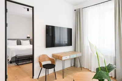 a bedroom with a bed and a desk and a mirror at Hiša Barbara in Celje