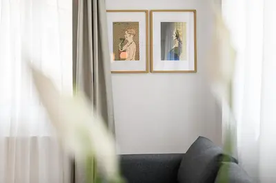 a room with two pictures on the wall and a couch at Hiša Barbara in Celje