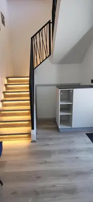 a room with stairs and a stair case at Apartments Na Žagi in Železniki