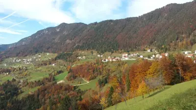 a valley in the mountains with houses and trees at Apartments Na Žagi in Železniki