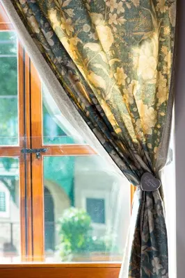 a curtain on a window in a room at Hotel Pri mostu in Dolenjske Toplice