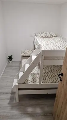 two bunk beds in a room with a door at Hiška Betnava - G115 in Podčetrtek