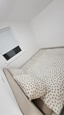 a bed with a pillow and a mirror on it at Hiška Betnava - G115 in Podčetrtek
