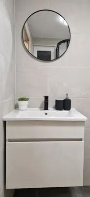 a bathroom with a white sink and a mirror at Hiška Betnava - G115 in Podčetrtek