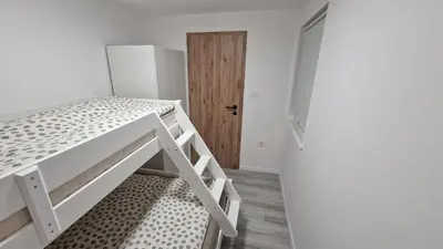a small room with a bunk bed and a door at Hiška Betnava - G115 in Podčetrtek