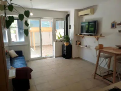 a living room with a couch and a television at Bistra in Ajdovščina