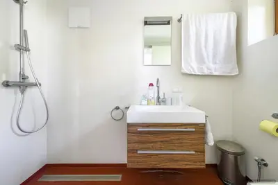 a bathroom with a sink and a mirror at Exklusive Premium-Lodge mit Pool, Sauna, Gästehaus