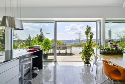 an open kitchen with a view of a dining table at Exklusive Premium-Lodge mit Pool, Sauna, Gästehaus
