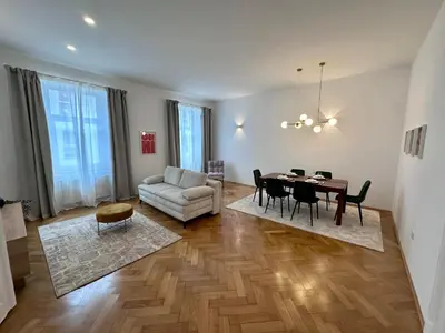 a living room with a table and a couch at Spacious Designer Apartment in heart of the town in Maribor