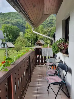 a balcony with a table and chairs and a view at Apartmaji Julijana Podlipnik in Bohinj