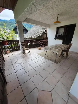 a patio with a table and chairs and a view at Apartmaji Julijana Podlipnik in Bohinj