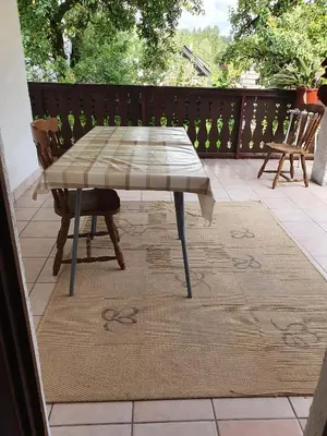 a table and chairs sitting on a patio at Apartmaji Julijana Podlipnik in Bohinj