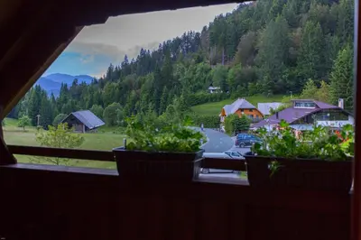 a view from a window of a village with a road at Brunarica Bled Zatrnik Pokljuka in Bled