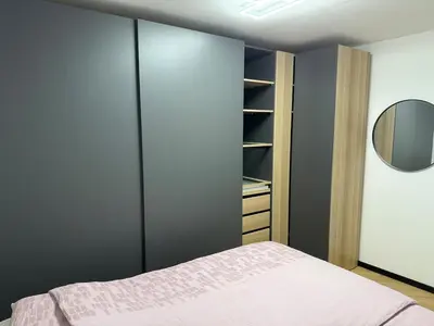 a bedroom with a bed and a closet at Moderno stanovanje - Ptuj in Ptuj