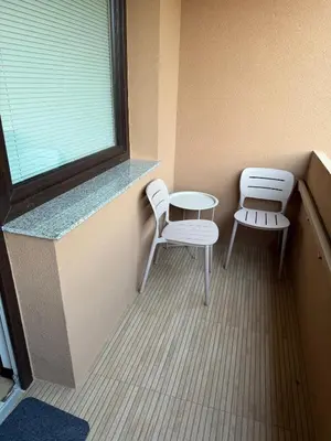 a room with two chairs and a table and a window at Moderno stanovanje - Ptuj in Ptuj