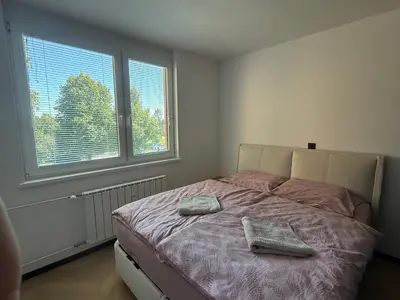 a bedroom with a bed with two towels on it at Moderno stanovanje - Ptuj in Ptuj