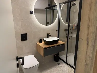 a bathroom with a sink and a toilet and a mirror at Moderno stanovanje - Ptuj in Ptuj