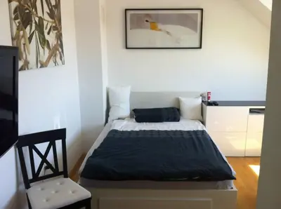 a small bedroom with a bed in a room at Andro's modern studio apartment in Ljubljana