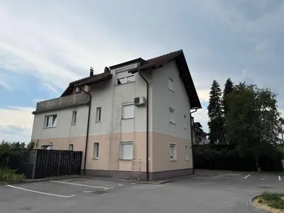 a large building with a parking lot at Andro's modern studio apartment in Ljubljana