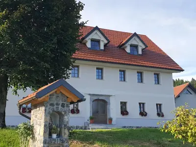 a white house with a red roof at Domačija Blaževc in Žiri