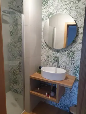 a bathroom with a sink and a mirror at Domačija Blaževc in Žiri